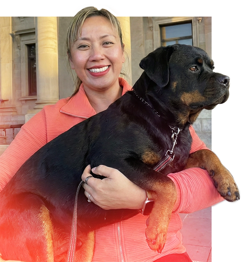 Liza Choa holding her rescue dog outside a building